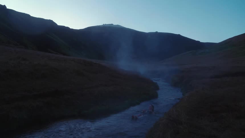 Iceland a person is sitting in a river during spring