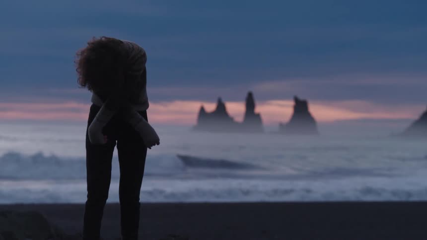 A woman stretching at the beach