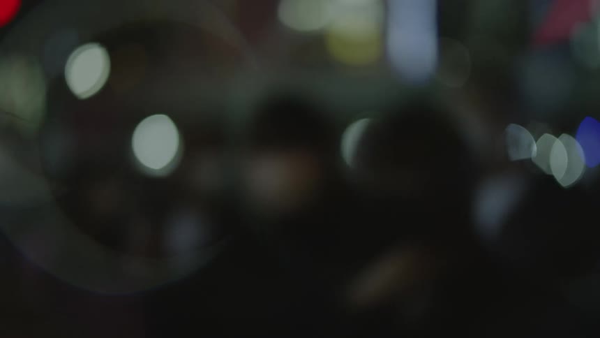 Unrecognizable anonymous people walk down the street in downtown area