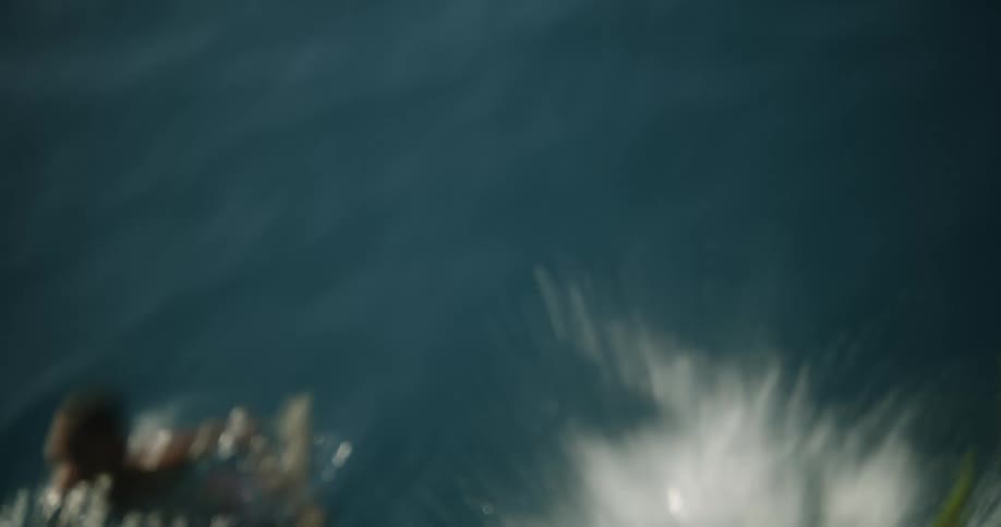 Two playful boys swimming on the lake at daytime