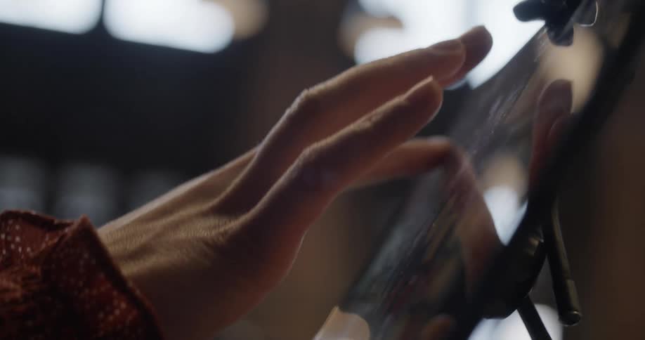 A person taps on a tablet