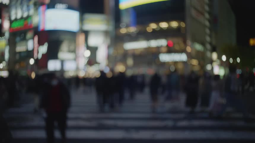 Pedestrians are walking on city streets at night