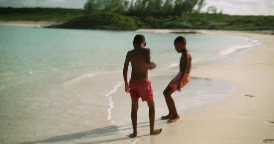 Children run out of the water playing