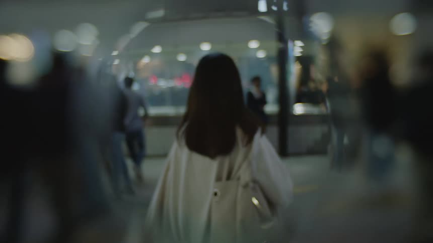 Woman walking through a crowded outdoor area