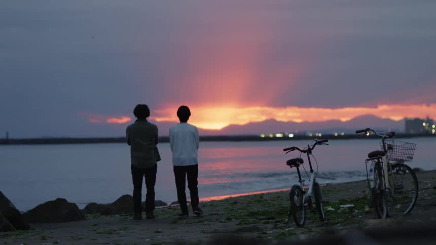 Two friends are hanging outdoors by the beach