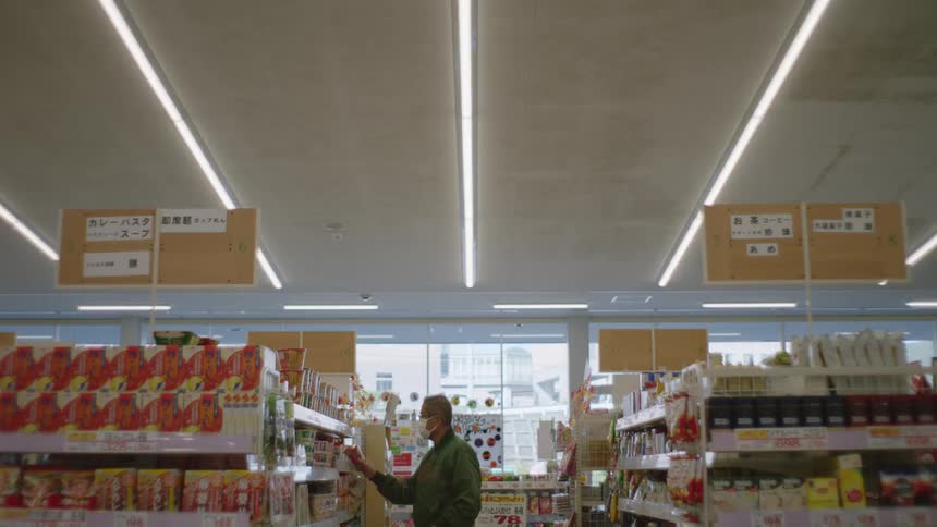 A man is shopping at a store during the daytime