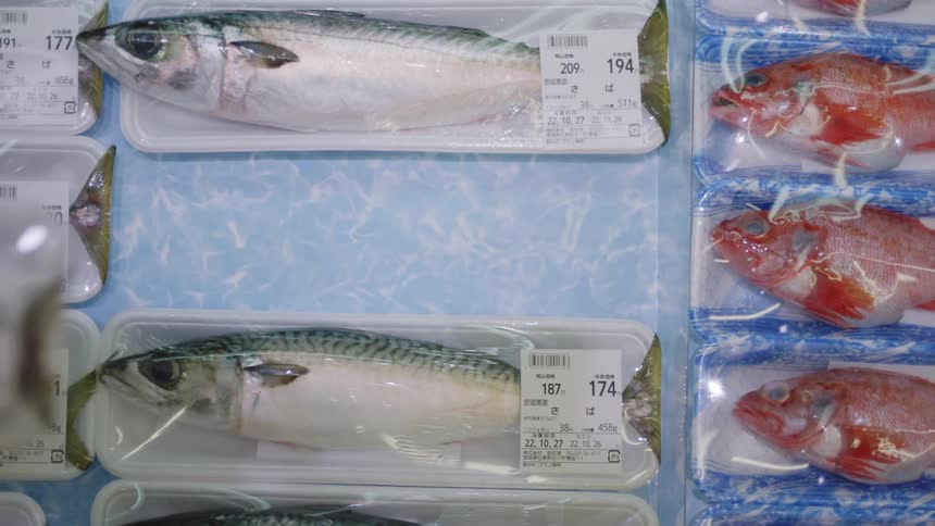 Hand picks out fish pack