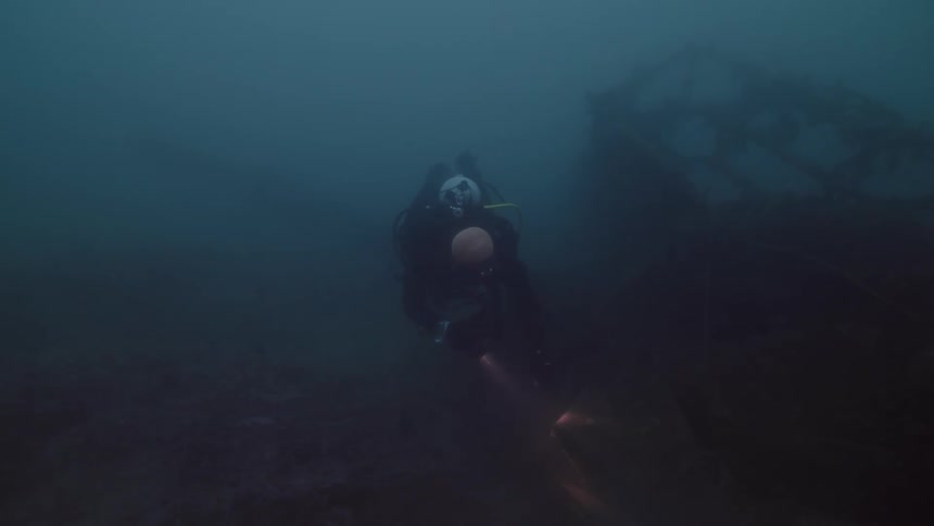 A person is scuba diving in the ocean water