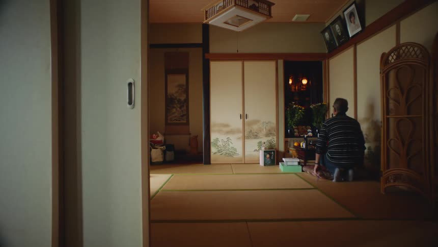 A man walks in and kneels by the table