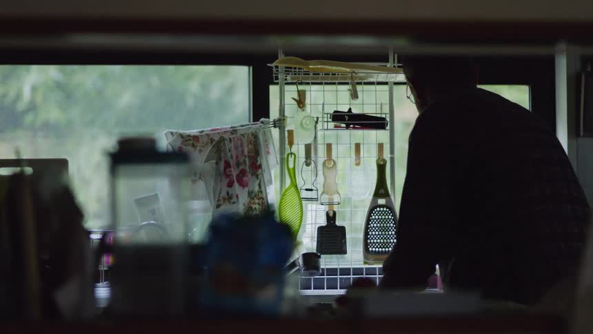 An older man is cleaning up his home in the day time