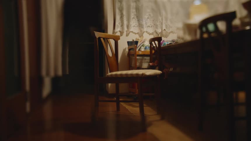 An empty chair next to dining table in a room
