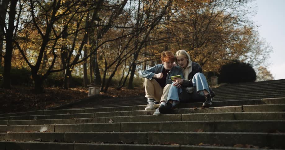 Two women talk on the steps