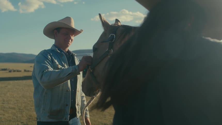 Man and woman are outdoors with their horse
