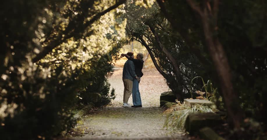 Boyfriend and girlfriend are kissing in a forest area