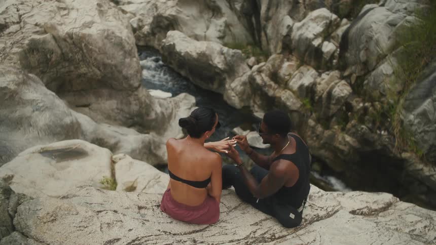 A young couple is being affection towards each other outside