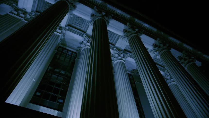 Close up view of a building in a city is displayed at night