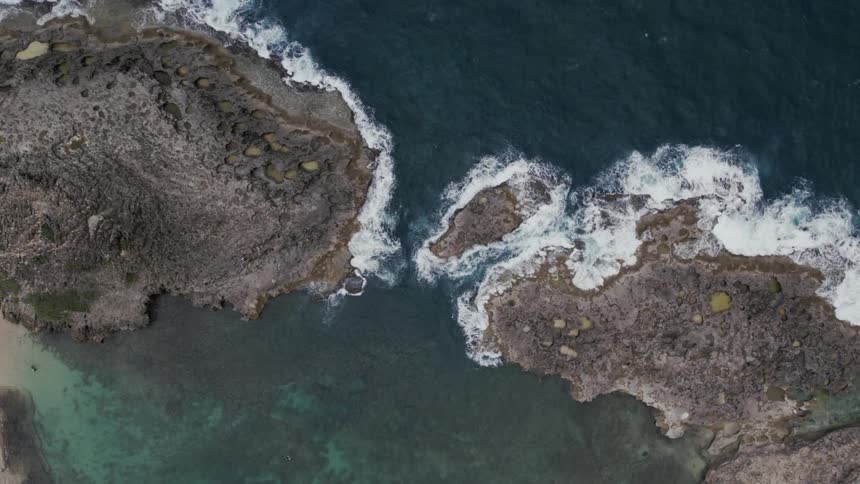 Birds eye view of ocean and island is displayed