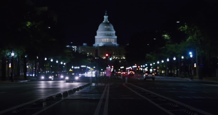 Cars and people are roaming the city streets at night