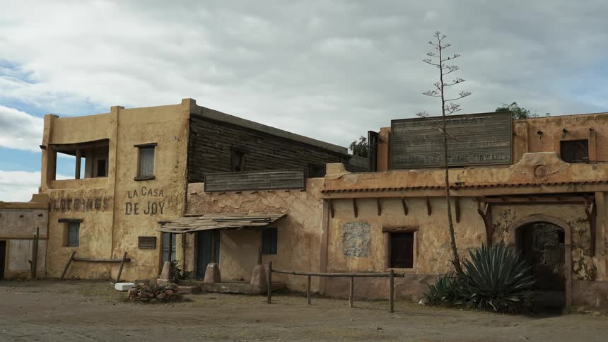 Windows are busted on an abandoned building in a Western ghost town