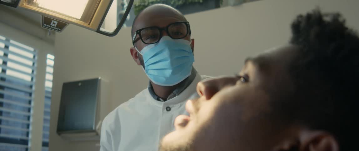 A doctor speaks with a patient about his mouth
