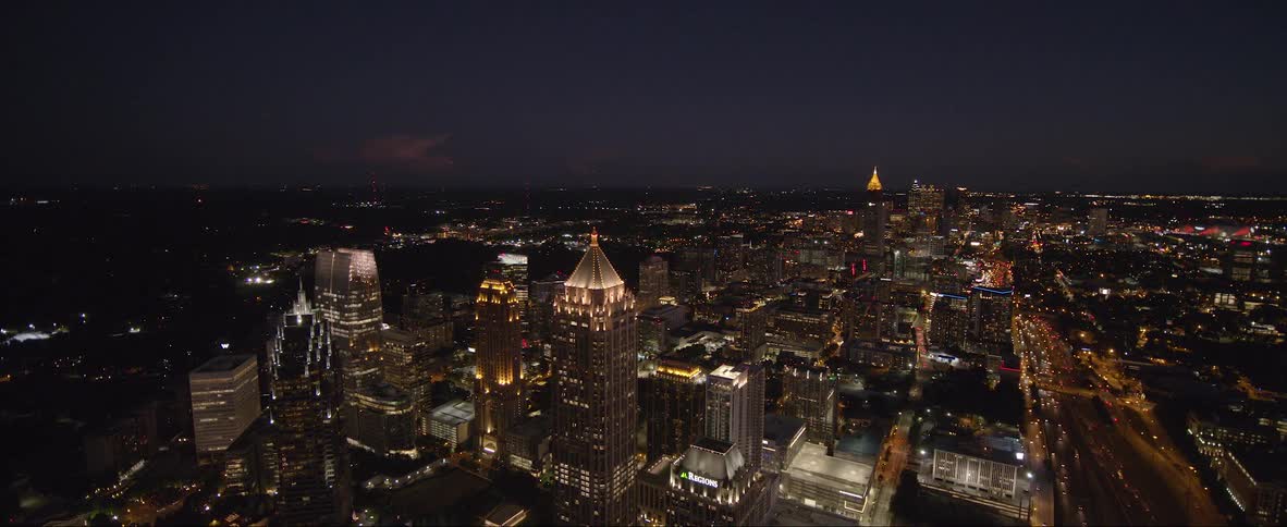 A bustling city is lit up at night