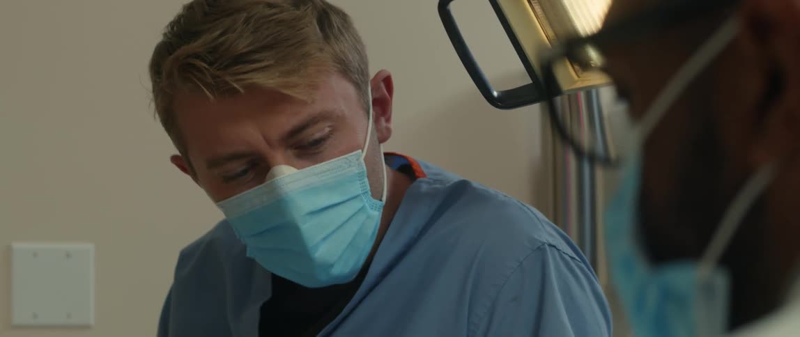 Two doctors chat in a hospital room