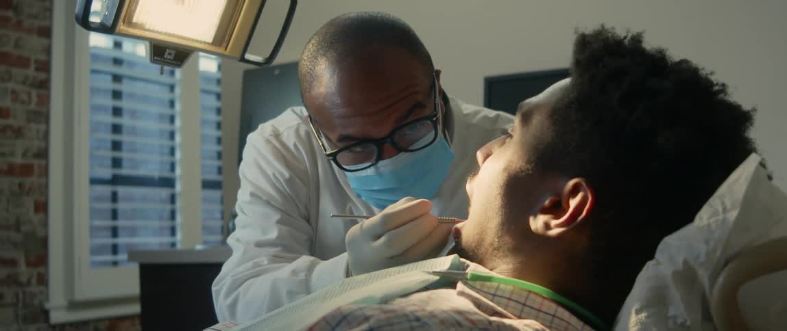 A dentist working on a patients teeth