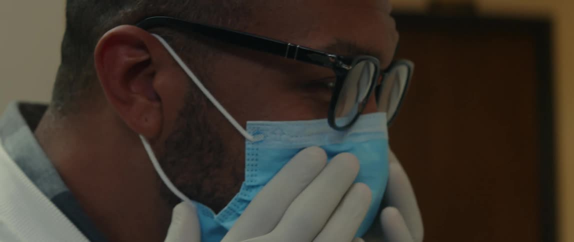 A doctor is talking to someone in his office