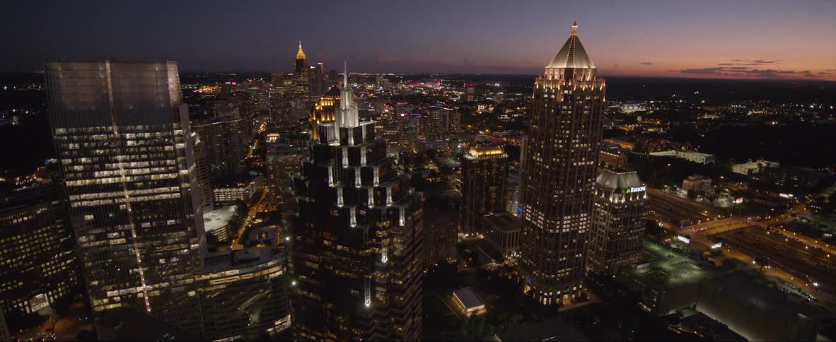 A bustling city is lit up at night