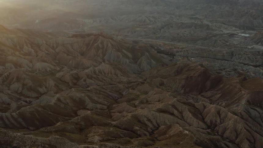 Aerial view of a badland desert area at dusk