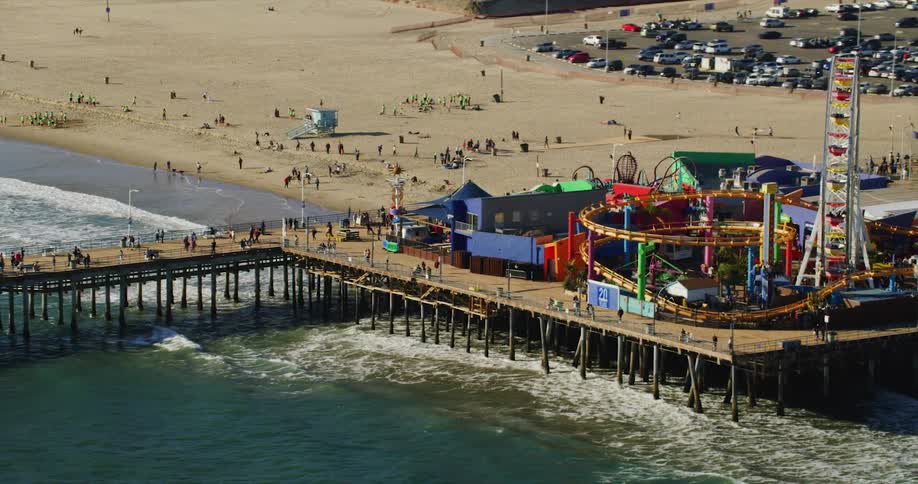 Aerial view of an amusement park over a pier on the beach at daytime