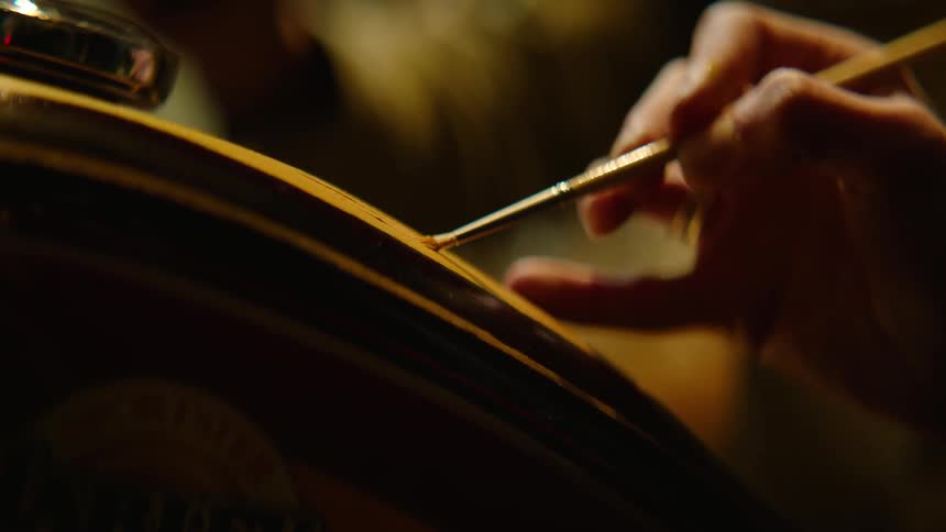 A woman paints on a canvas