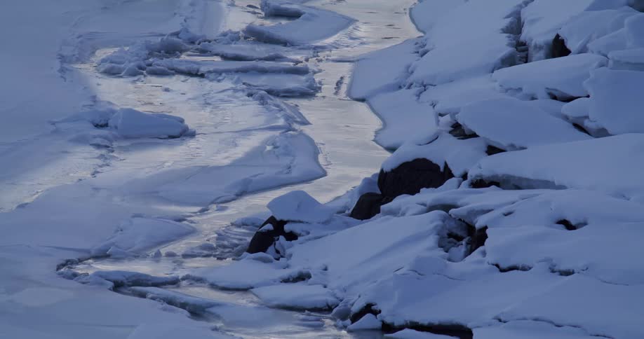 An aerial view of a mountain area covered in snow