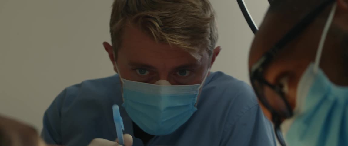 A dentist examining and cleaning a patients teeth