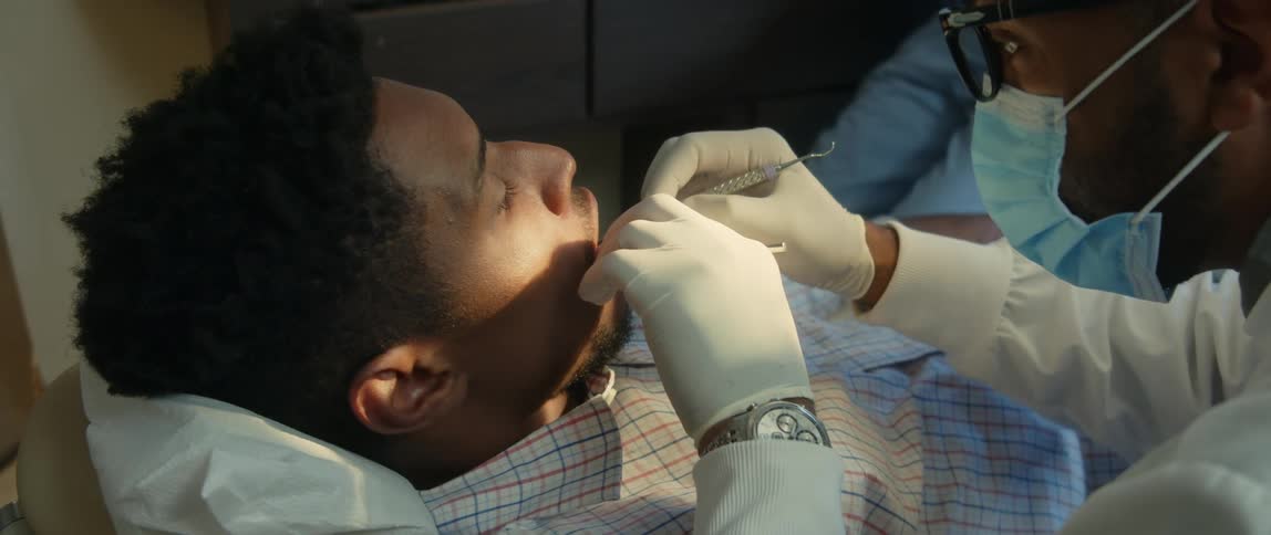 A young patient is at a clinic and the doctor is doing some medical procedure