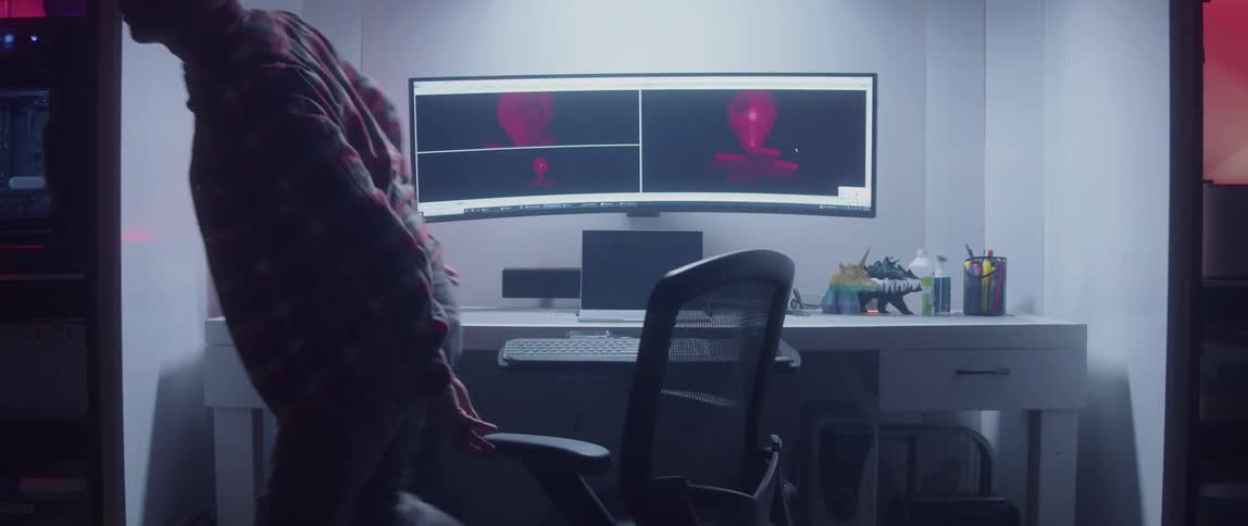 A man getting up from a computer