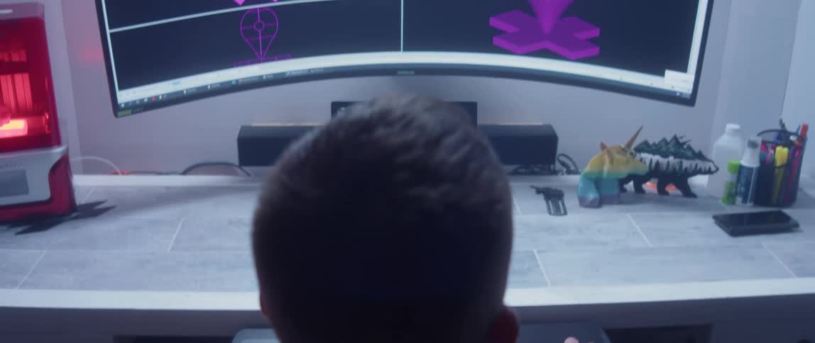 A man designing items on a computer screen