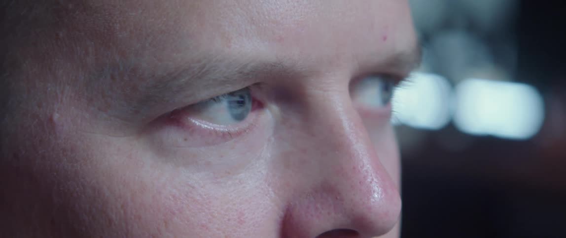 A man with blue eyes blinking and looking from side to side