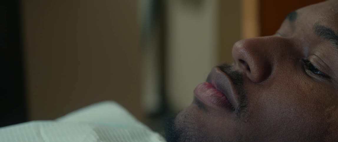 Male patient sits in dentist chair as it reclines then light shines on his face