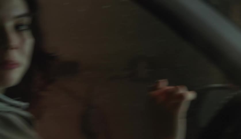 Two women sit in a car and talk to each other