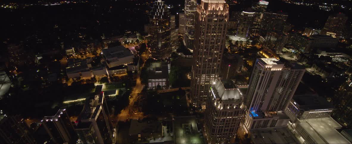 Aerial view of a downtown city at night is displayed