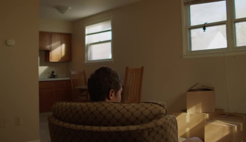 Man with special needs sitting on a spinning chair in the living room