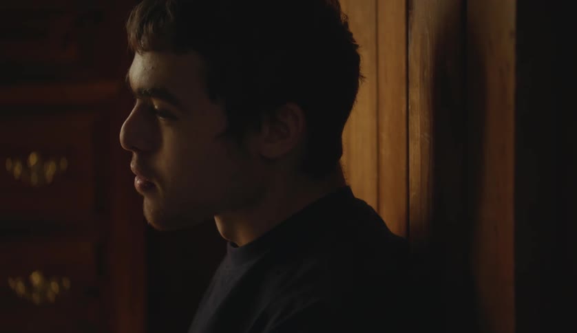 Young man with special needs eating while talking on a room at home
