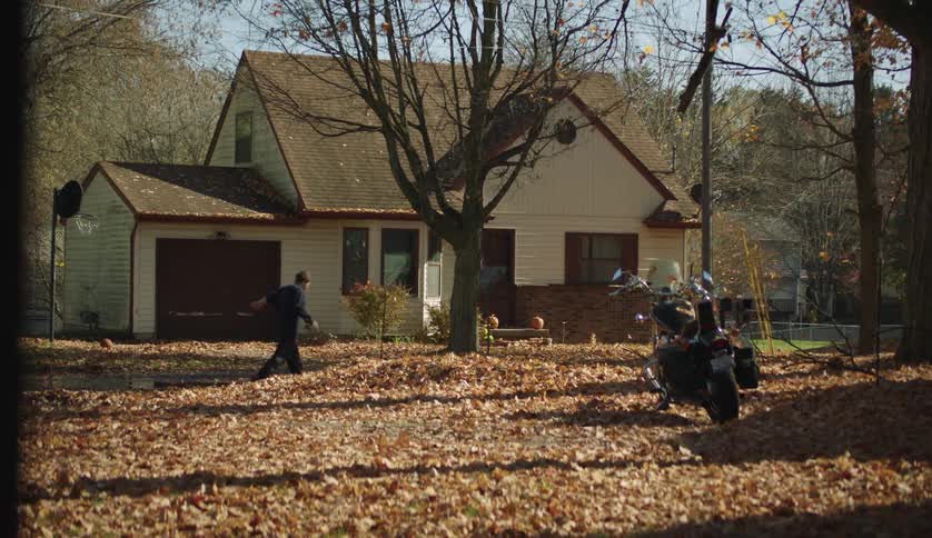 Two adults are outside by there house in the day time