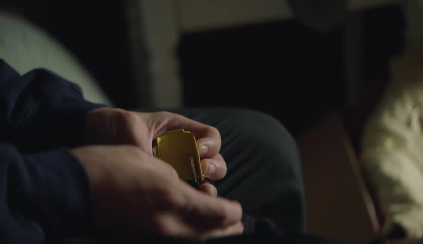 Male hands holding and turning over a mini toy truck