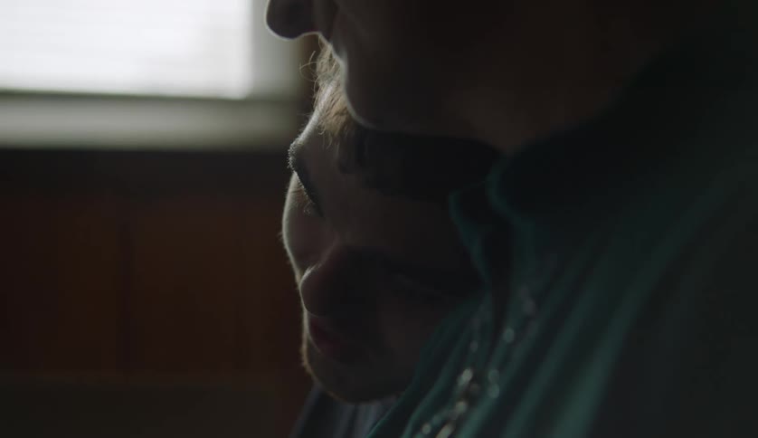 A teenage boy and mother are hanging out together inside