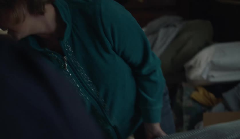 Woman and man lift and moves mattress in room