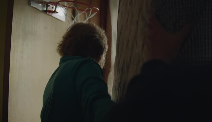 Grandmother and grandson moving a mattress from one room to another