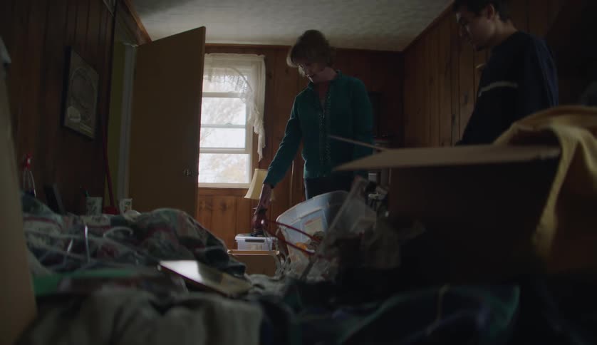 Grandmother and grandson tidying up a room at home