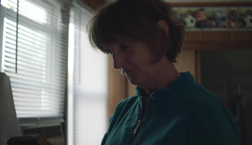 A woman is walking around her house during the daytime